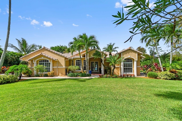 mediterranean / spanish-style house with a front lawn