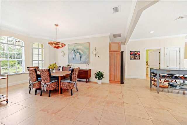 tiled dining space featuring ornamental molding and an inviting chandelier