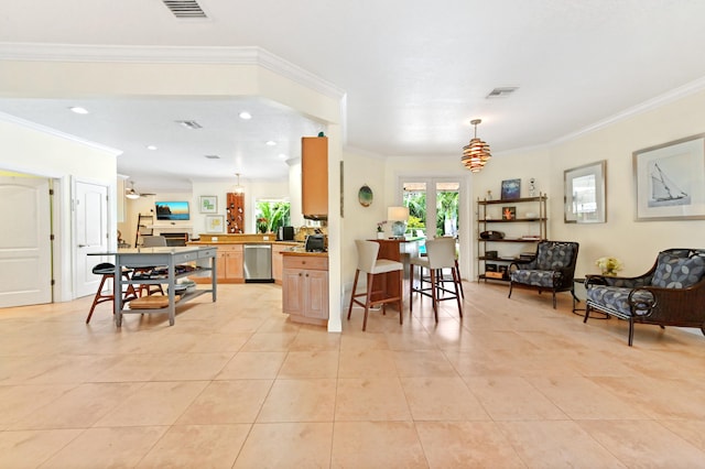 kitchen featuring a kitchen bar, stainless steel dishwasher, ceiling fan, crown molding, and light tile patterned floors