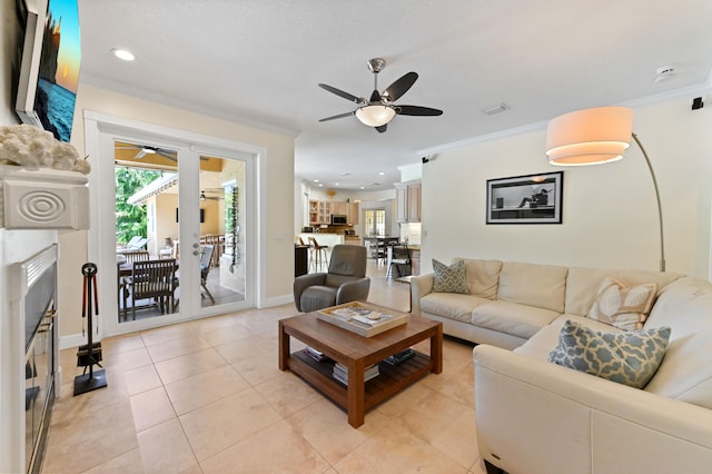 living room featuring ceiling fan, french doors, light tile patterned floors, and ornamental molding