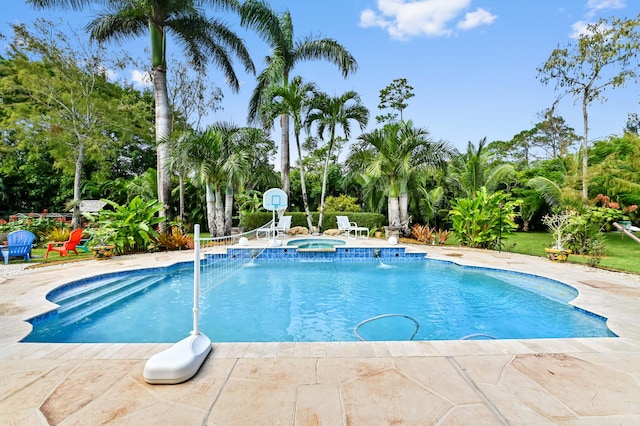 view of pool with an in ground hot tub, pool water feature, and a patio