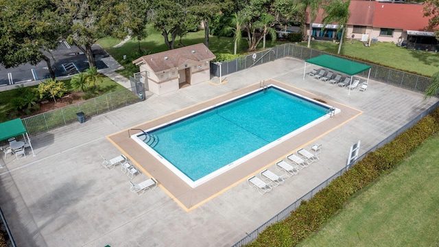 view of swimming pool featuring a yard and a patio area