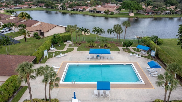 view of swimming pool featuring a patio area and a water view