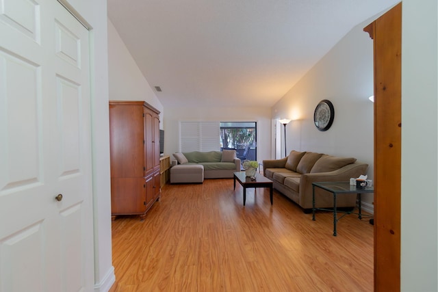 living room with light wood-type flooring and lofted ceiling