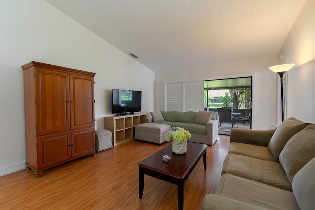 14 Grange Pl, Boynton Beach, FL 33426 - living area with vaulted ceiling, light wood-style floors, and a textured ceiling