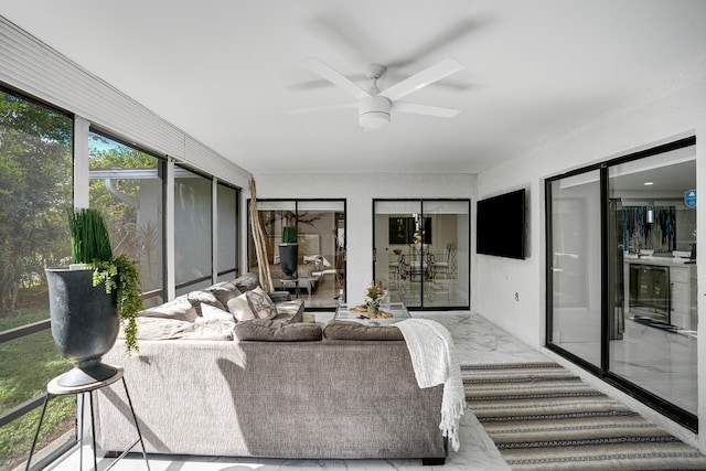 sunroom with ceiling fan and beverage cooler