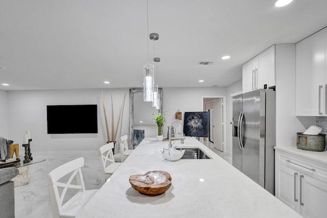 dining room with a barn door and sink