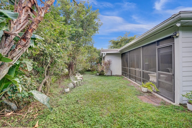 view of yard featuring a sunroom