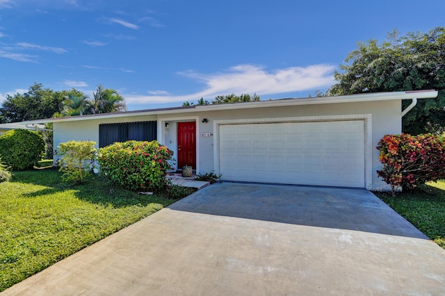 ranch-style house with a garage and a front lawn