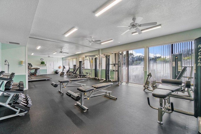 workout area with ceiling fan and a textured ceiling