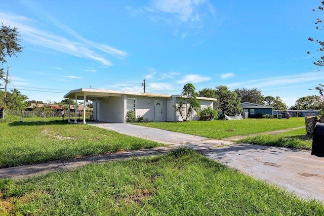 view of front facade with a front yard and a carport