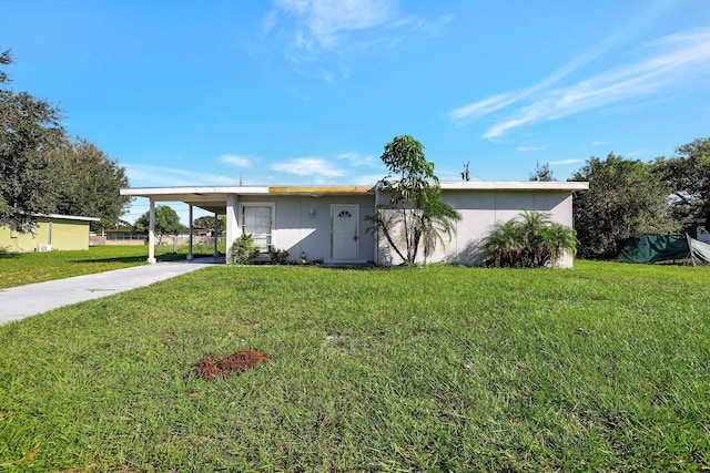 ranch-style home with a carport and a front yard