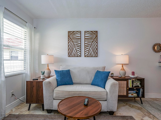 living area featuring a textured ceiling