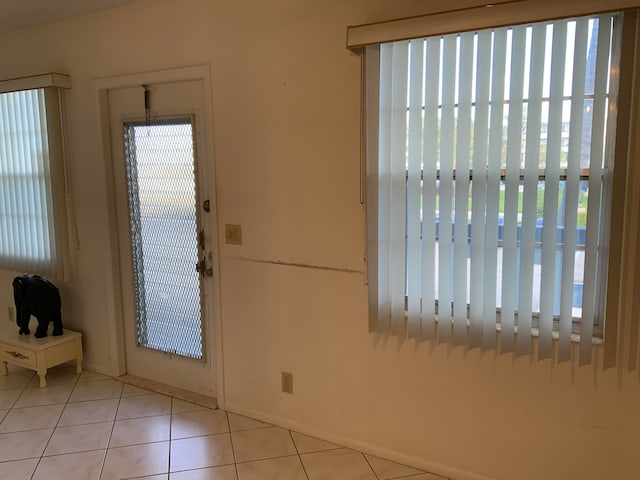 entryway with plenty of natural light and light tile patterned floors