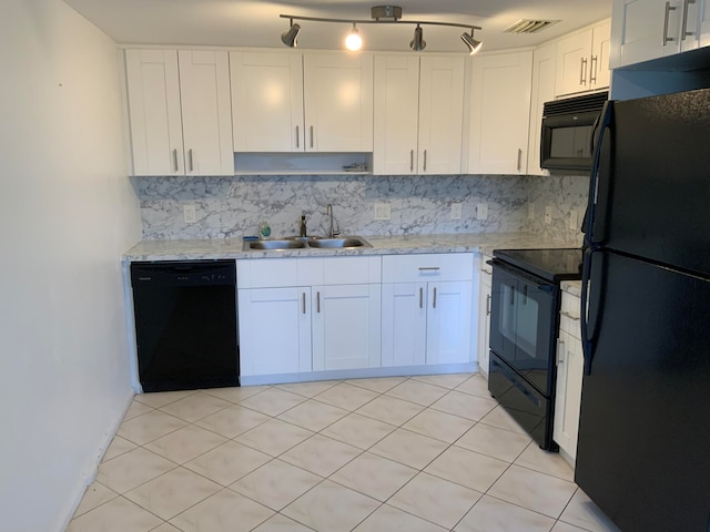 kitchen featuring backsplash, sink, white cabinetry, and black appliances