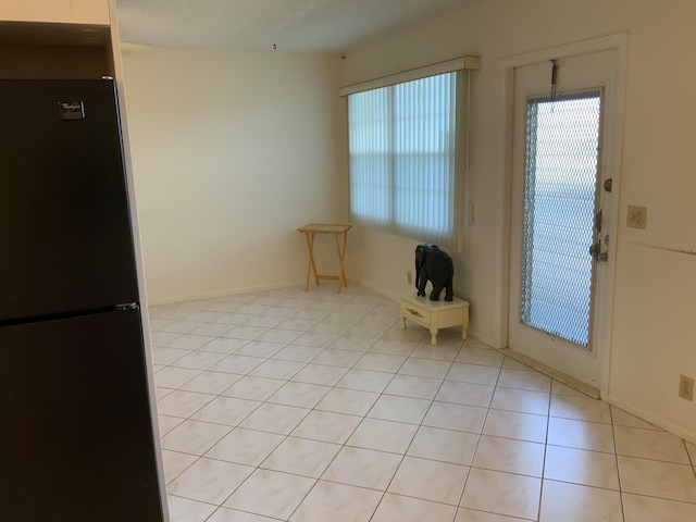 doorway to outside featuring light tile patterned flooring