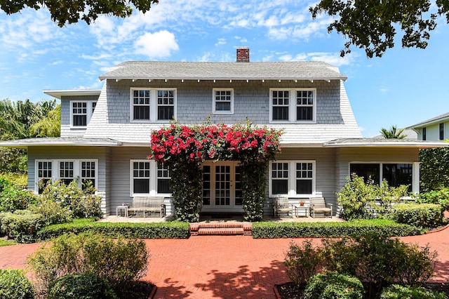 back of house featuring a chimney and a patio