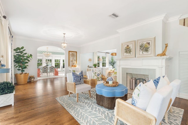 living area with ornamental molding and dark hardwood / wood-style floors