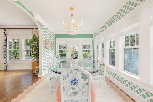 sunroom / solarium with a chandelier