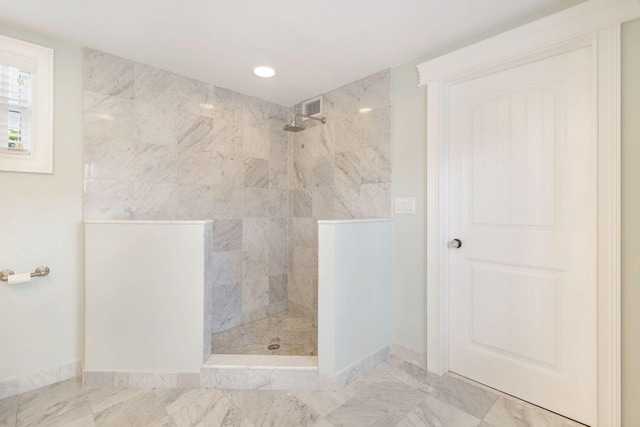 bathroom featuring tiled shower