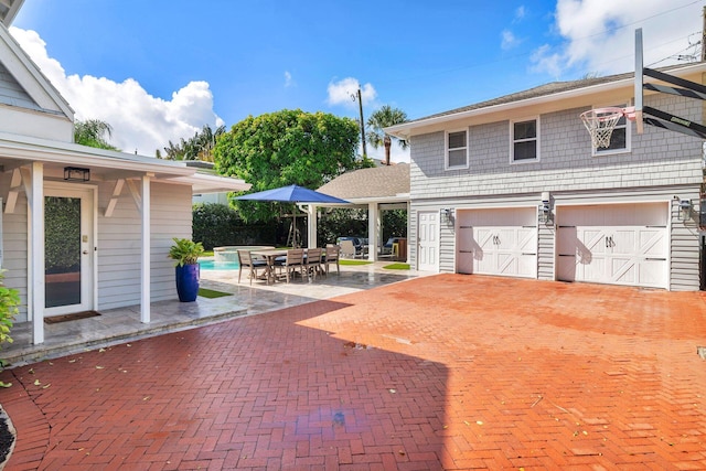 exterior space featuring a garage and a patio