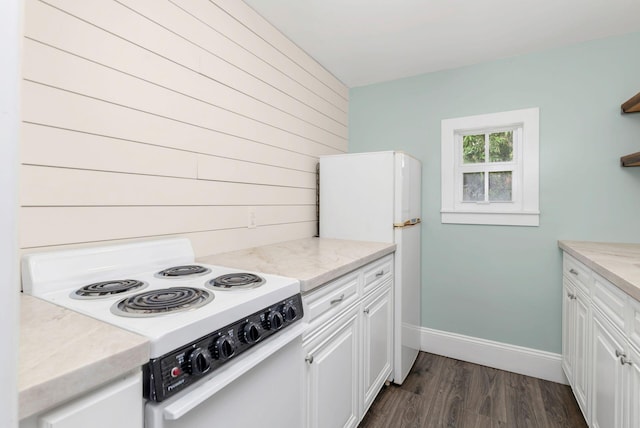 kitchen featuring dark wood-type flooring, white cabinetry, and white appliances