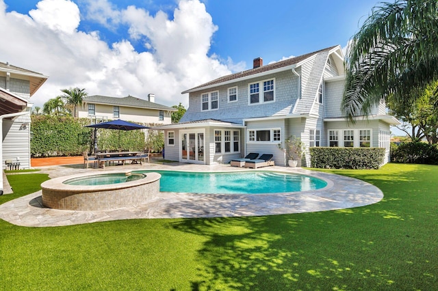 view of swimming pool featuring an in ground hot tub, a patio, and a yard