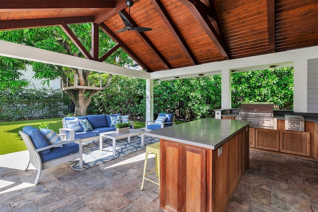 view of patio / terrace featuring area for grilling, an outdoor hangout area, exterior kitchen, a gazebo, and ceiling fan