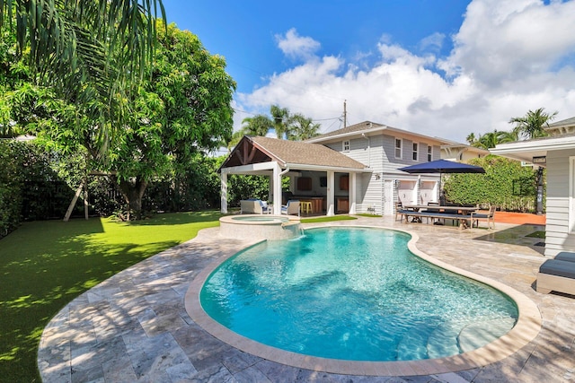 view of swimming pool with an in ground hot tub, a patio, and a lawn