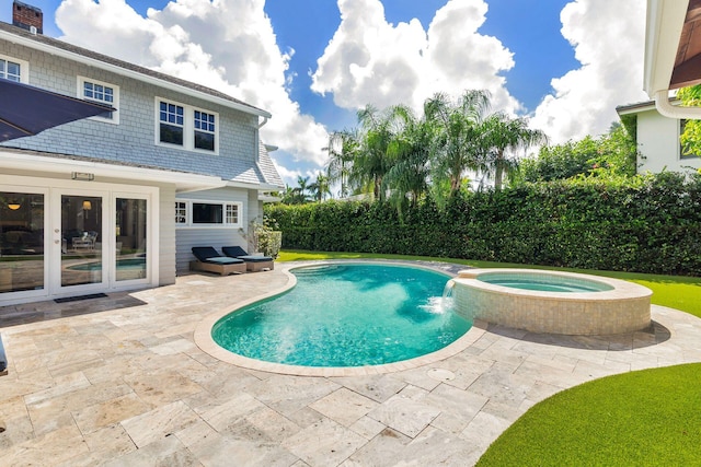 view of pool with an in ground hot tub and a patio area