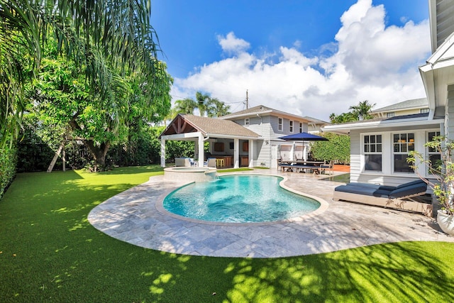 view of pool featuring a yard, a patio area, and a wooden deck