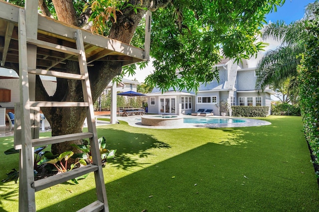 view of yard with a patio area and a pool with hot tub