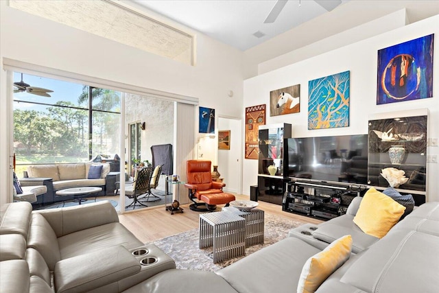 living room with hardwood / wood-style flooring and ceiling fan