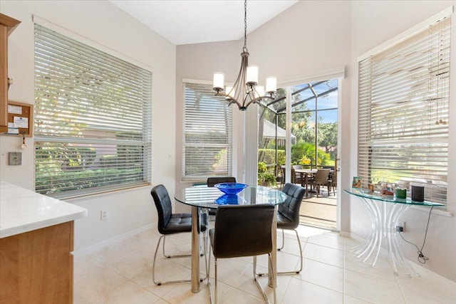 dining room with a chandelier, light tile patterned flooring, and vaulted ceiling