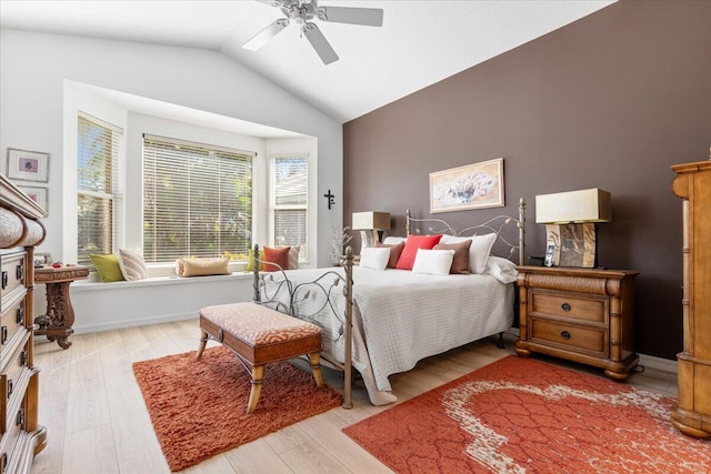 bedroom with vaulted ceiling, light hardwood / wood-style flooring, and ceiling fan