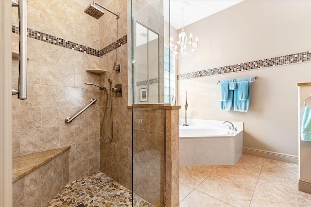 bathroom featuring a notable chandelier, tile patterned floors, and shower with separate bathtub