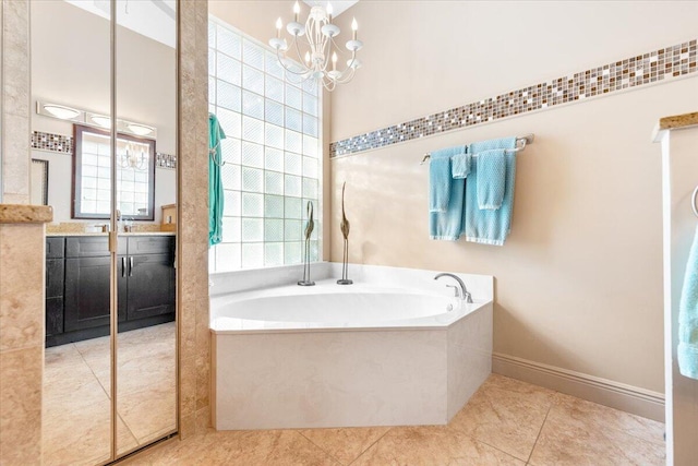 bathroom with vanity, a relaxing tiled tub, a chandelier, and tile patterned floors