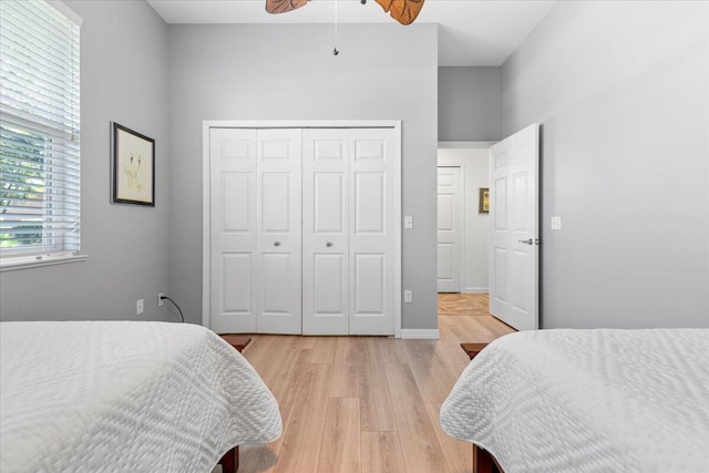 bedroom featuring a closet, light hardwood / wood-style floors, and ceiling fan