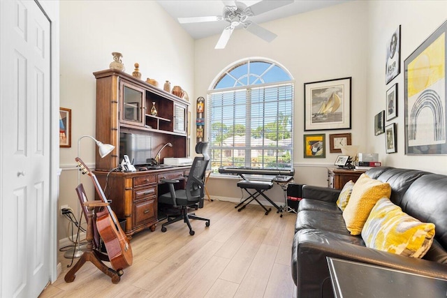 office space featuring light hardwood / wood-style floors, lofted ceiling, plenty of natural light, and ceiling fan