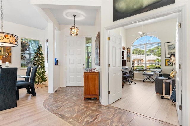 foyer entrance featuring light hardwood / wood-style floors and ceiling fan