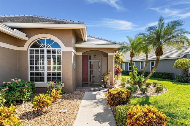 property entrance featuring a lawn