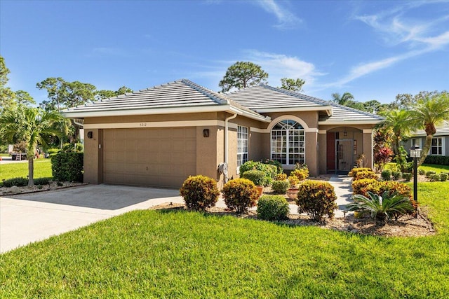 ranch-style house featuring a garage and a front lawn