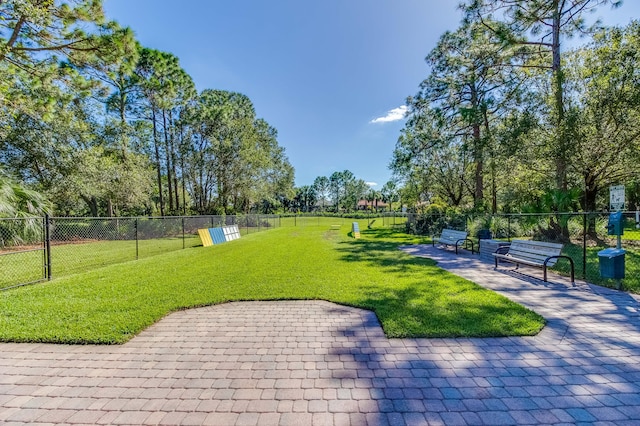 view of property's community with a yard and a patio area