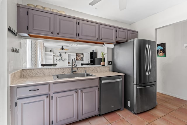 kitchen featuring sink, ceiling fan, gray cabinetry, stainless steel appliances, and light tile patterned flooring