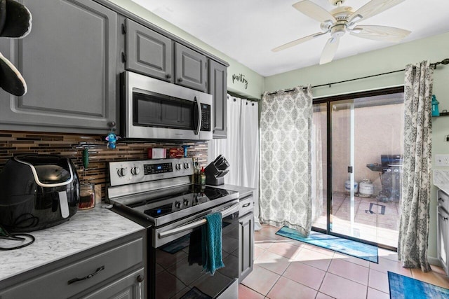 kitchen featuring ceiling fan, appliances with stainless steel finishes, plenty of natural light, and gray cabinets