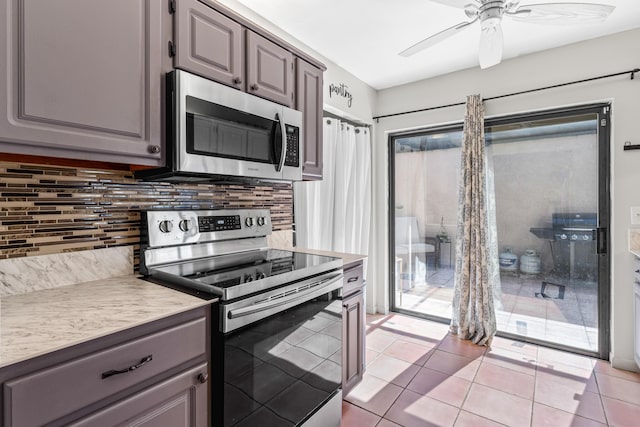 kitchen with appliances with stainless steel finishes, light tile patterned floors, backsplash, and ceiling fan