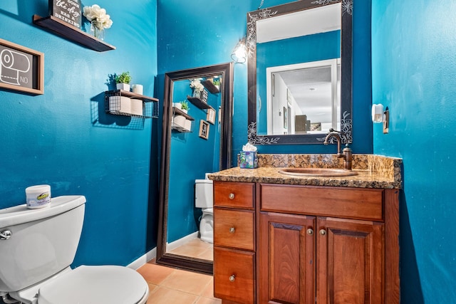 bathroom with vanity, toilet, and tile patterned flooring