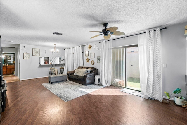 living room featuring a textured ceiling, a wealth of natural light, and hardwood / wood-style floors