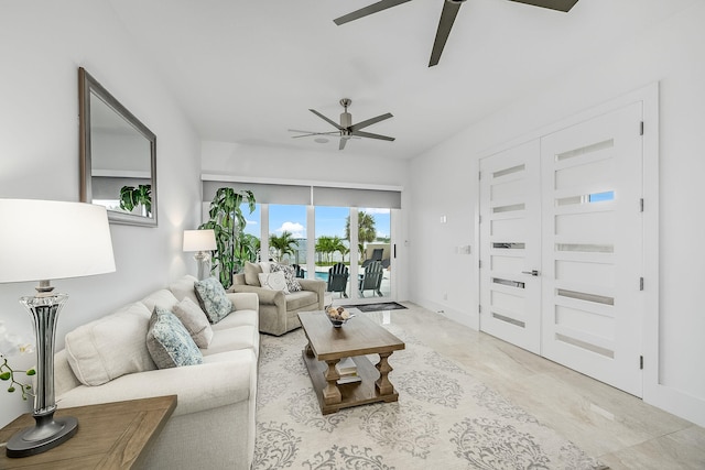 living room with ceiling fan and french doors