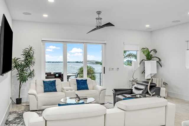 living room featuring a water view and ceiling fan